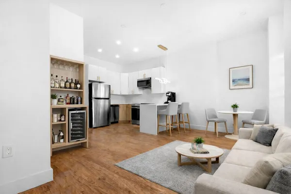 a living room with furniture and kitchen view