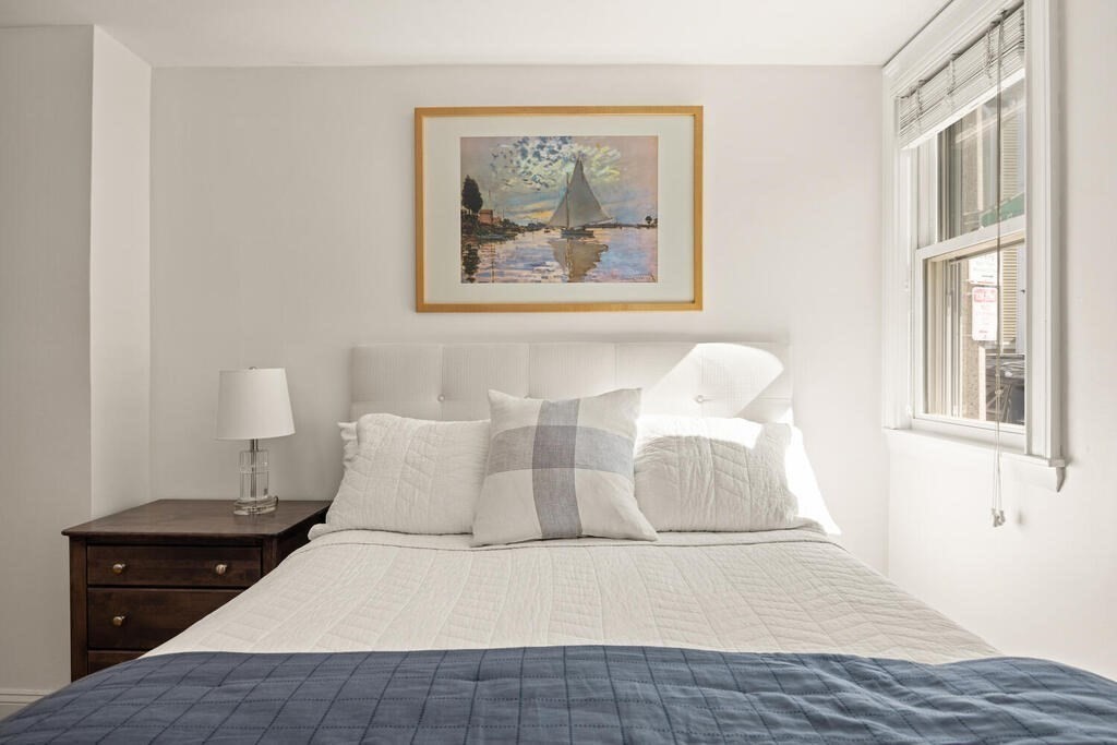 280 E Street, Unit 1 Boston, MA 02127 - Photo 12 of 19 a bedroom with a bed and a painting on the wall