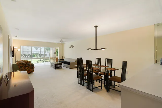 a room with chairs and large window