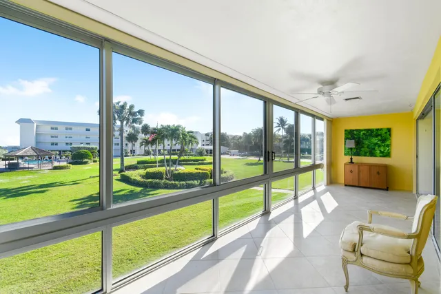 a view of a porch with furniture and garden