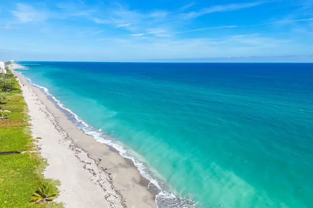 an aerial view of a pool patio and mountain view in back