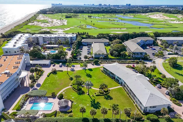 an aerial view of a resort with swimming pool and ocean view
