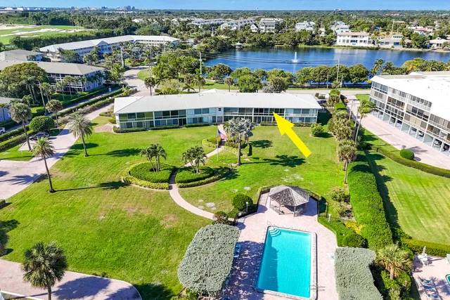 an aerial view of residential houses with outdoor space and swimming pool
