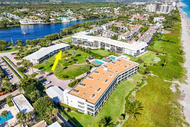 an aerial view of residential houses with outdoor space and swimming pool