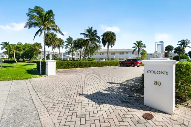 a street sign on a sidewalk next to a road