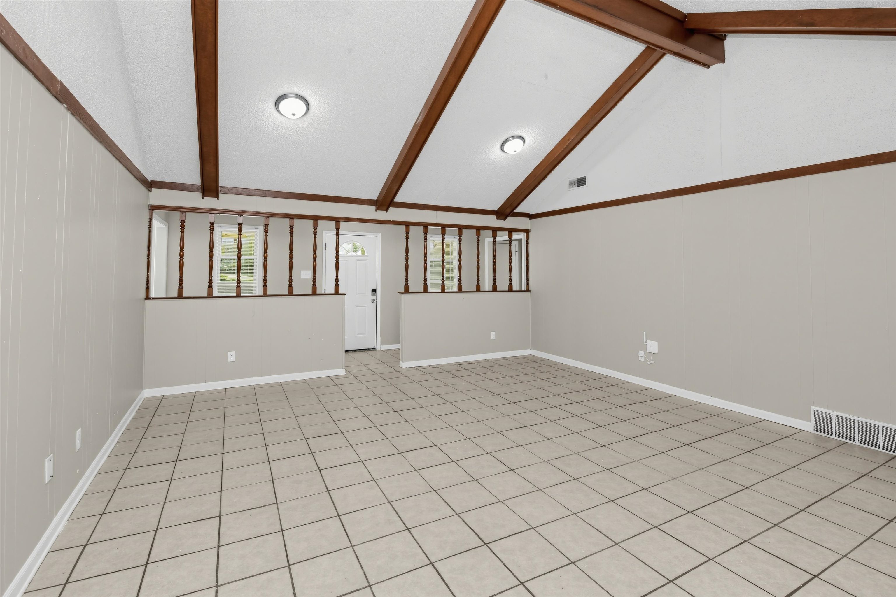 6350 Midsummer Way Memphis, TN 38115 - Photo 4 of 21 Vaulted ceiling with exposed wood beams, tiled flooring, recessed lighting, and half-wall with wood spindles