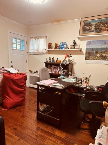 a bedroom with bed and wooden floor