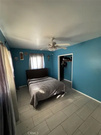 a spacious bedroom with a bed and a window