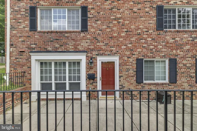 a view of a brick house with large windows