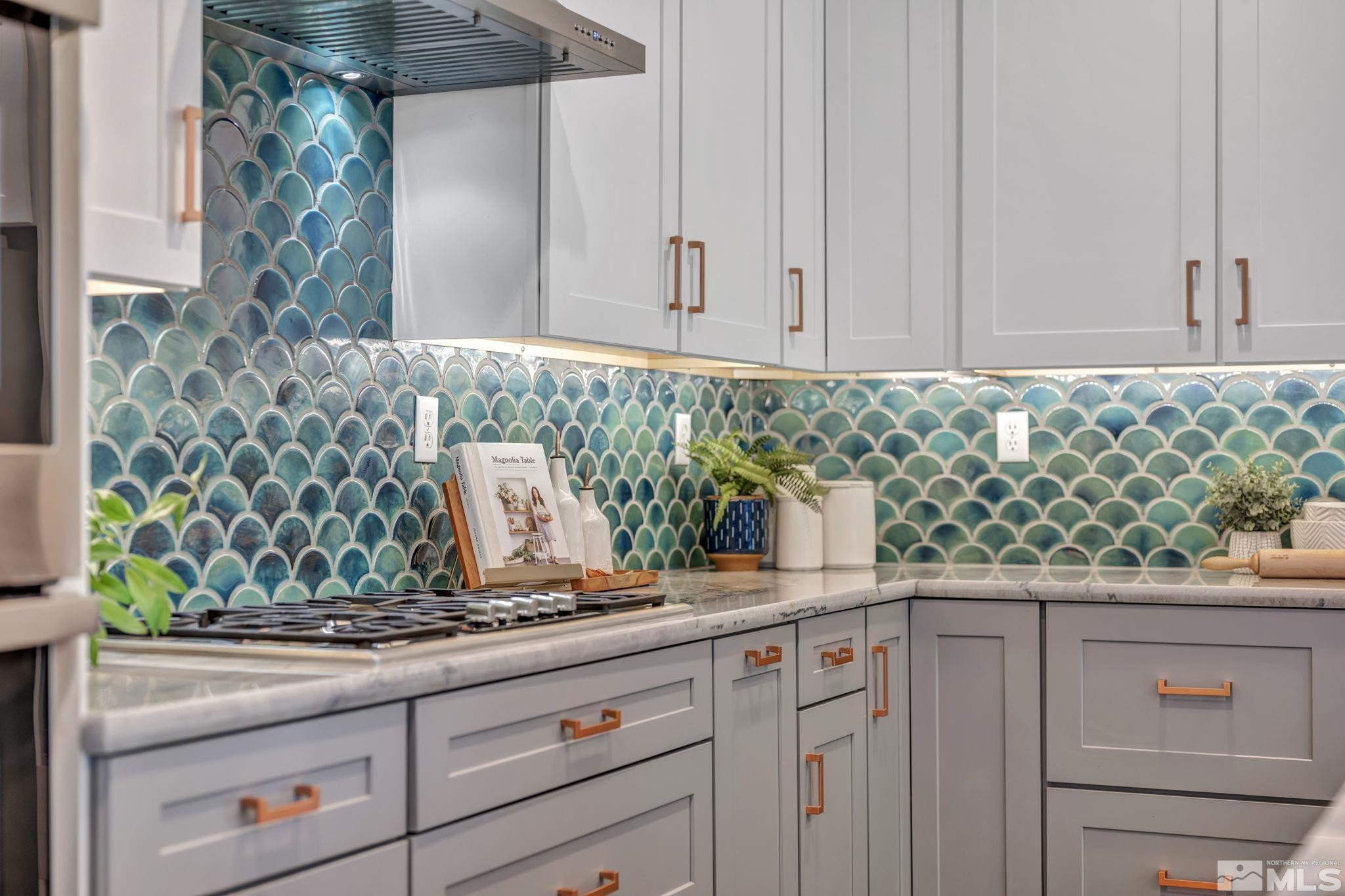 11355 Crotone Way Reno, NV 89521 - Photo 14 of 39 a kitchen with granite countertop white cabinets and stainless steel appliances