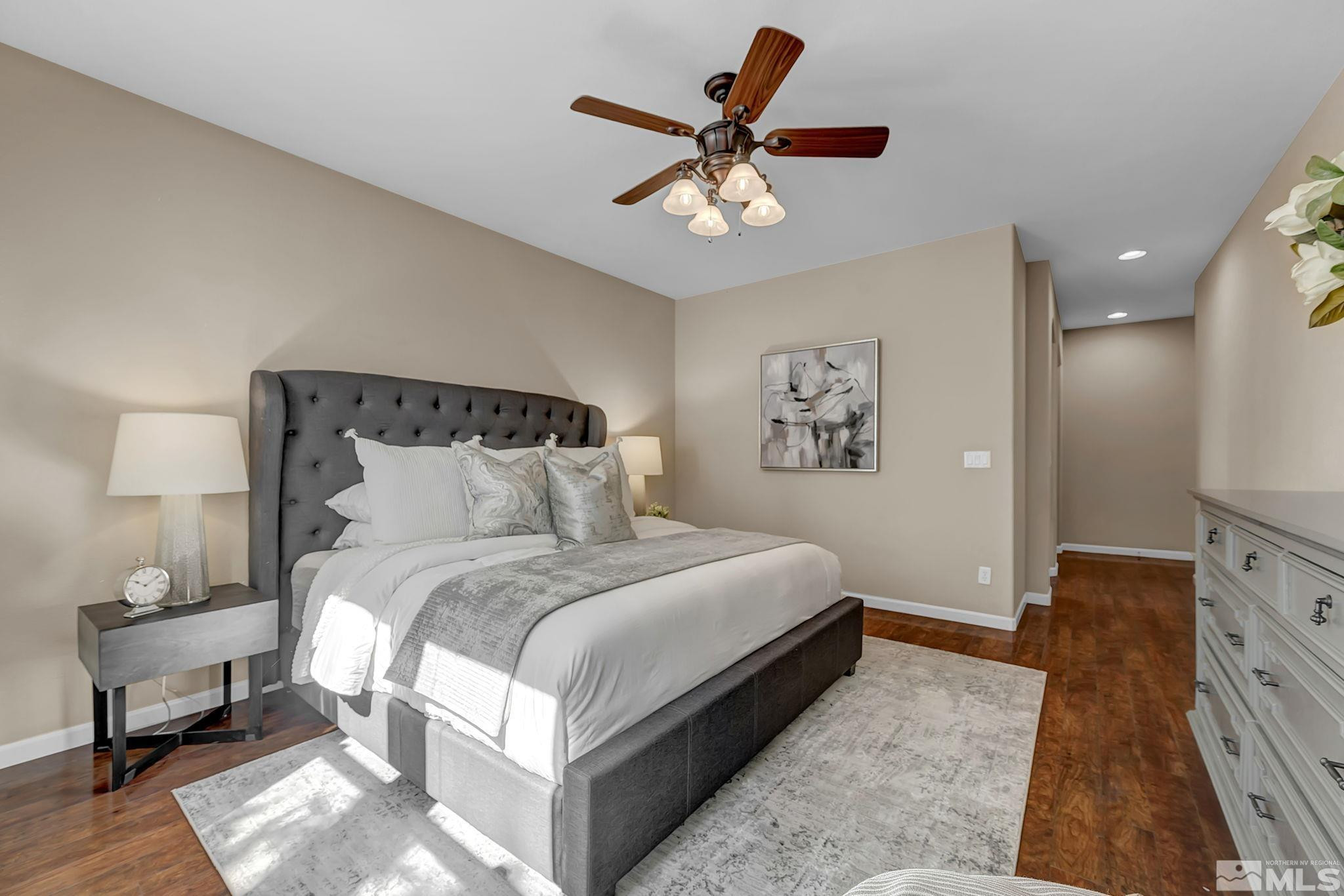11355 Crotone Way Reno, NV 89521 - Photo 22 of 39 a bedroom with bed and a chandelier