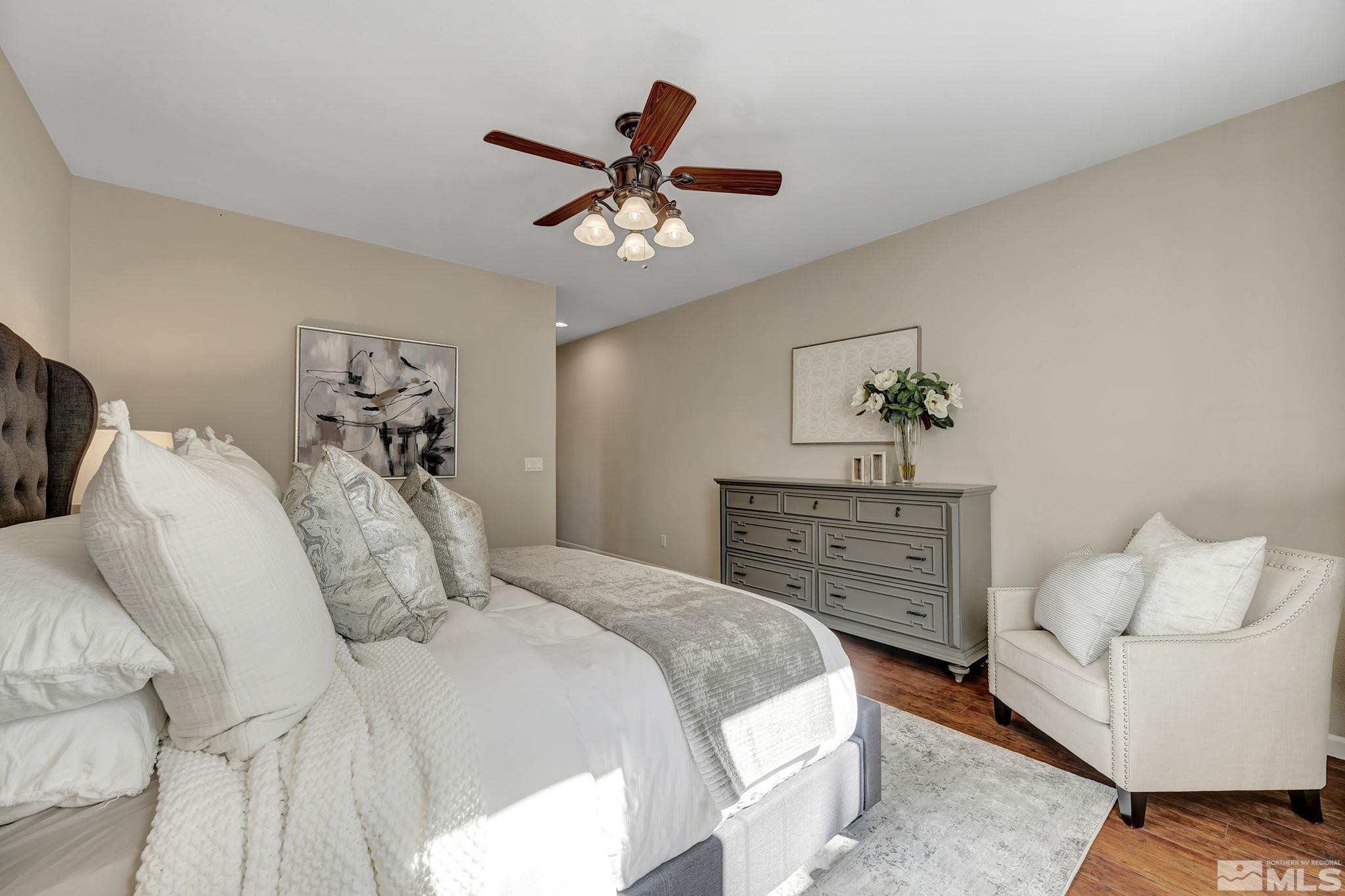 11355 Crotone Way Reno, NV 89521 - Photo 23 of 39 a bedroom with a bed and ceiling fan