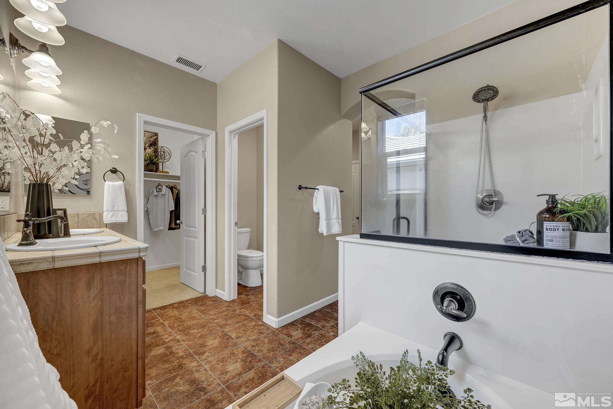 11355 Crotone Way Reno, NV 89521 - Photo 26 of 39 a bathroom with a sink a mirror and shower