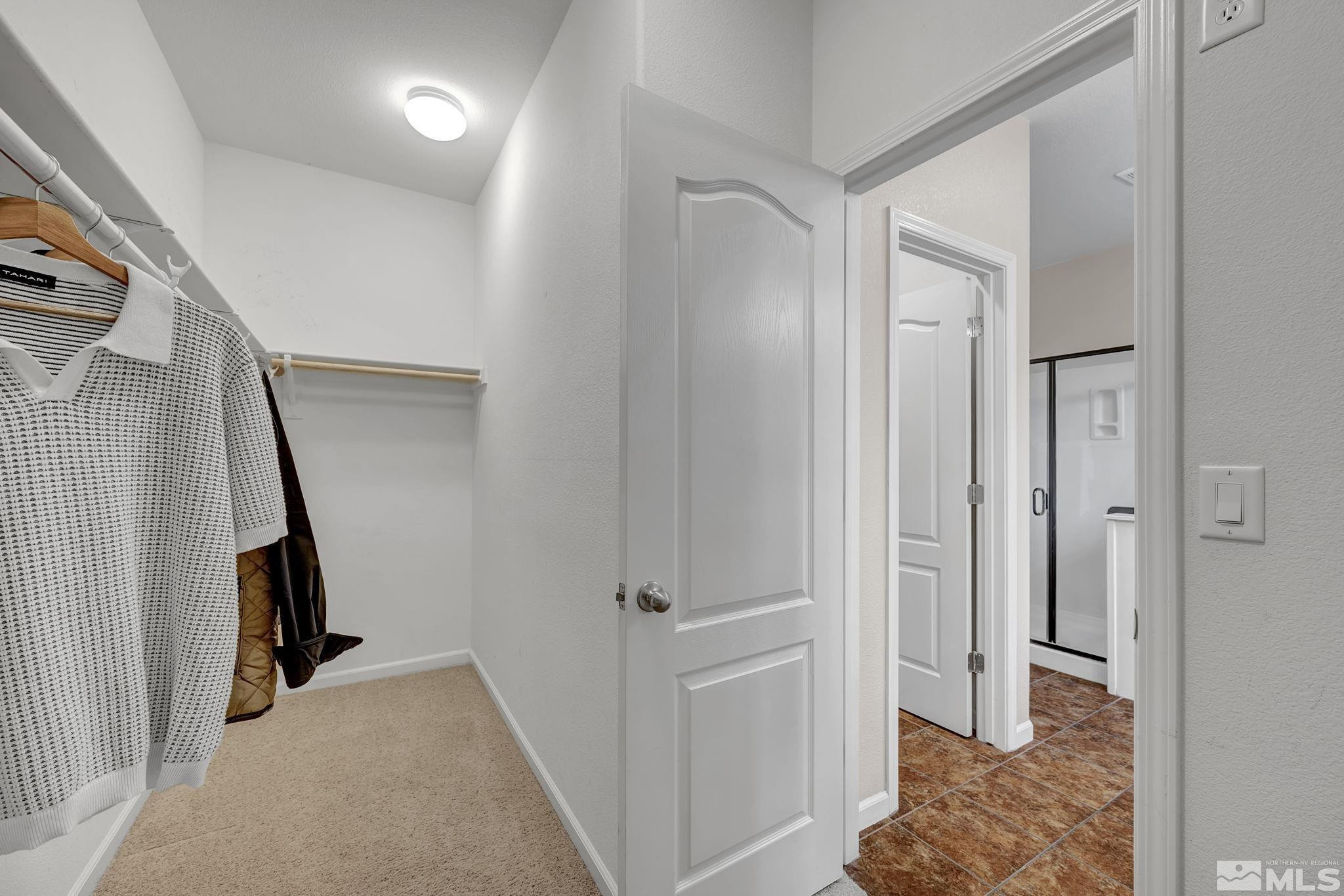 11355 Crotone Way Reno, NV 89521 - Photo 29 of 39 a view of a hallway with bathroom and wooden floor