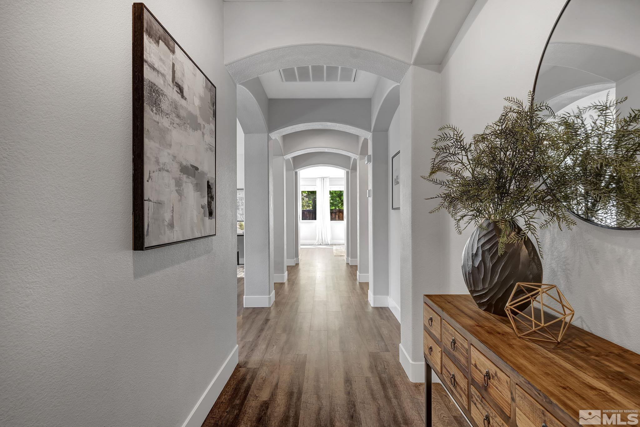 11355 Crotone Way Reno, NV 89521 - Photo 4 of 39 a view of a hallway with wooden floor and front door