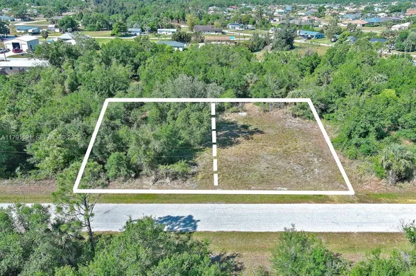 an aerial view of residential houses with outdoor space and swimming pool