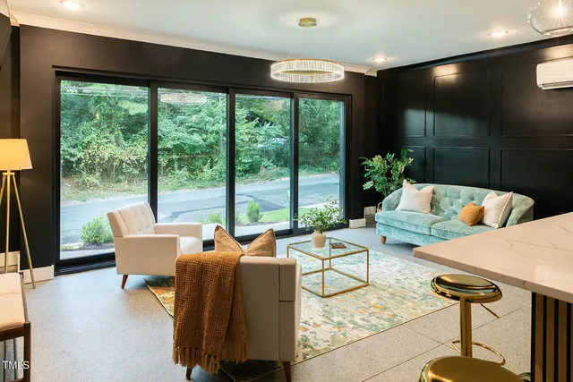 a living room with furniture and a floor to ceiling window
