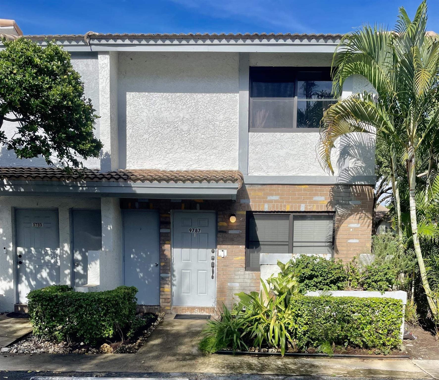 9787 Riverside Drive, Unit 624 Coral Springs, FL 33071 - Photo 1 of 21 a front view of a house with garden