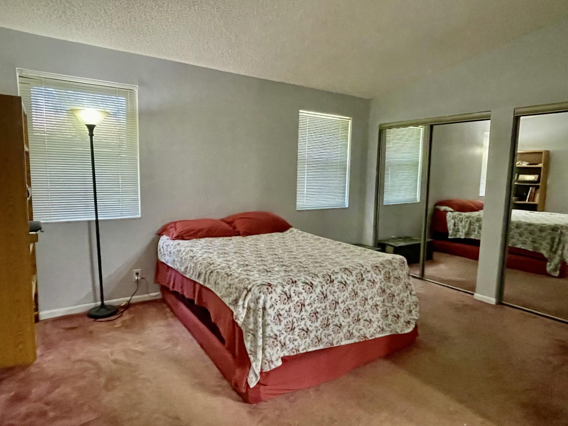 9787 Riverside Drive, Unit 624 Coral Springs, FL 33071 - Photo 12 of 21 a bedroom with a bed and a table in it