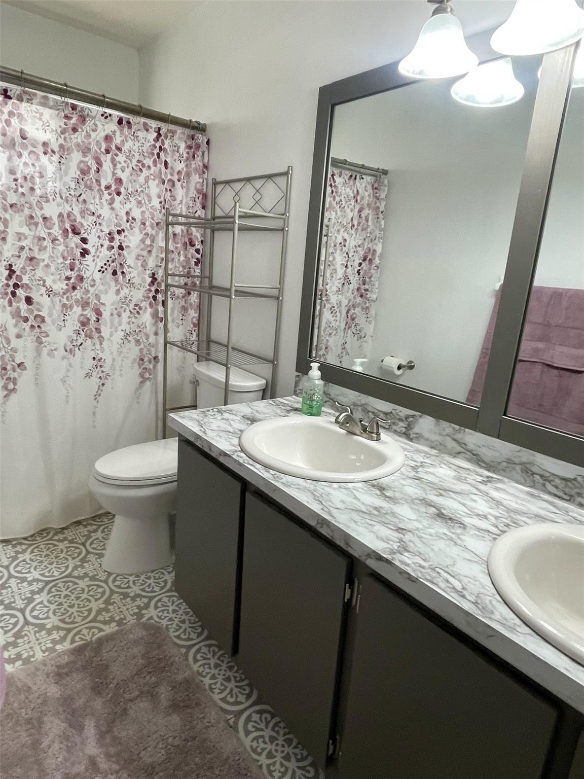 9787 Riverside Drive, Unit 624 Coral Springs, FL 33071 - Photo 13 of 21 a bathroom with a granite countertop sink toilet and a mirror