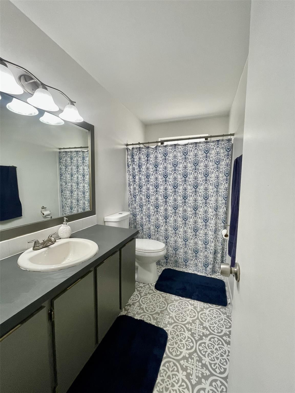 9787 Riverside Drive, Unit 624 Coral Springs, FL 33071 - Photo 15 of 21 a bathroom with a sink a toilet a mirror and shower