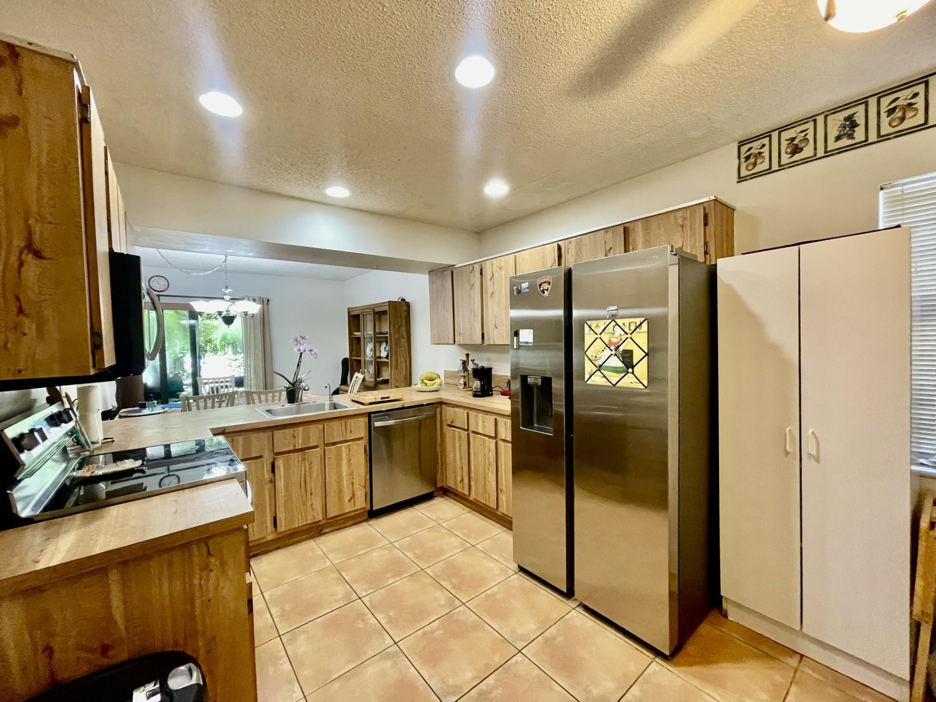9787 Riverside Drive, Unit 624 Coral Springs, FL 33071 - Photo 5 of 21 a kitchen with a refrigerator and a sink