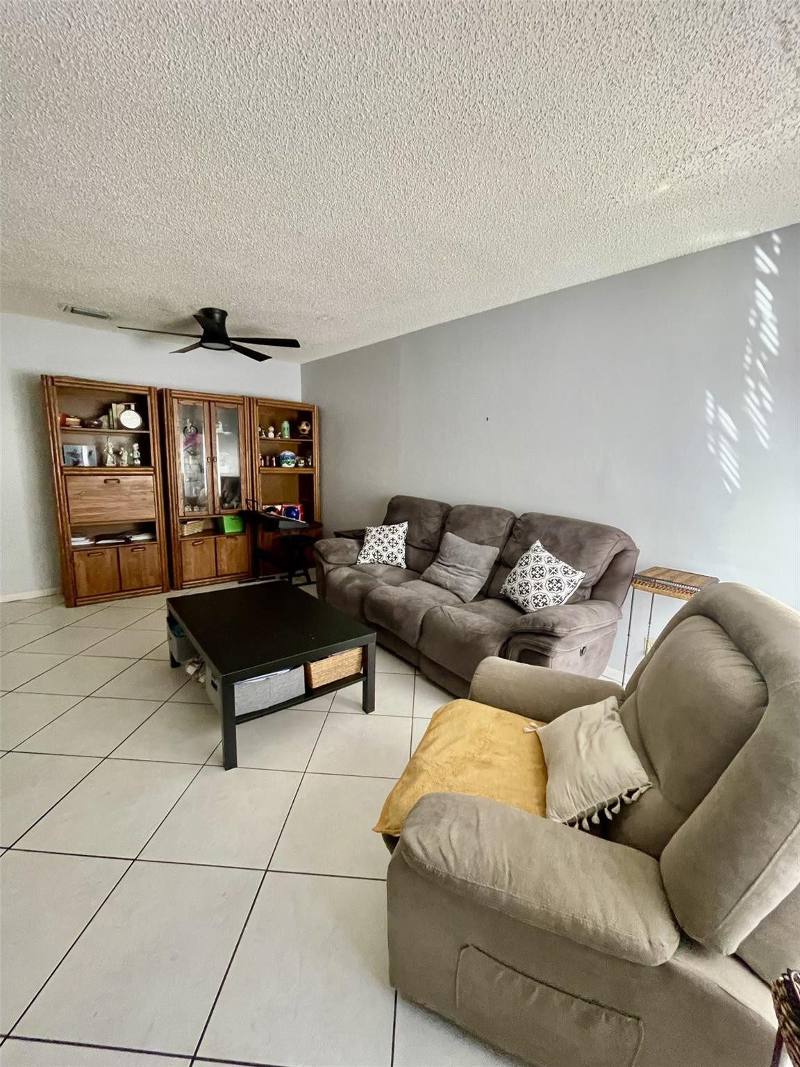 9787 Riverside Drive, Unit 624 Coral Springs, FL 33071 - Photo 10 of 21 a living room with furniture and a rug