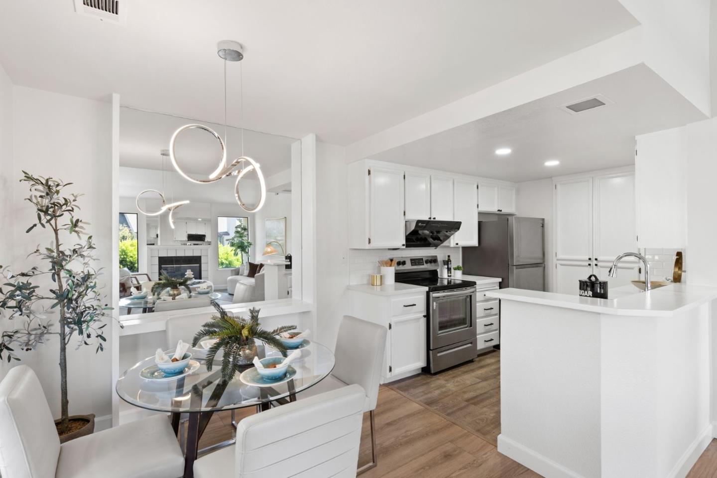 38872 Cherry Glen Common Fremont, CA 94536 - Photo 11 of 22 a living room with stainless steel appliances kitchen island granite countertop furniture a rug kitchen view and a chandelier