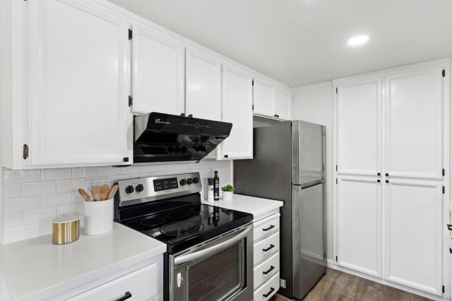 38872 Cherry Glen Common Fremont, CA 94536 - Photo 12 of 22 a kitchen with a stove and a refrigerator