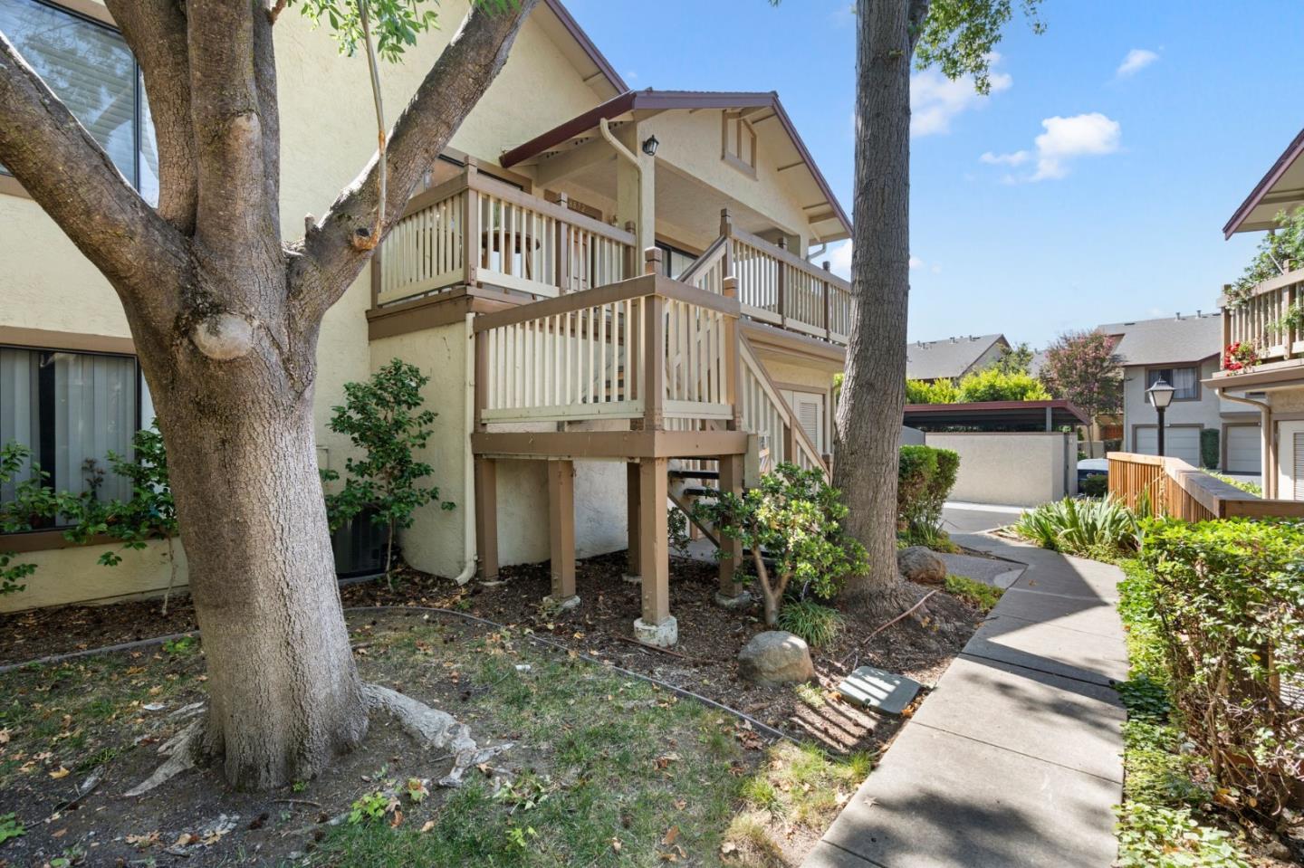 38872 Cherry Glen Common Fremont, CA 94536 - Photo 3 of 22 a view of a street with potted plants and a large tree