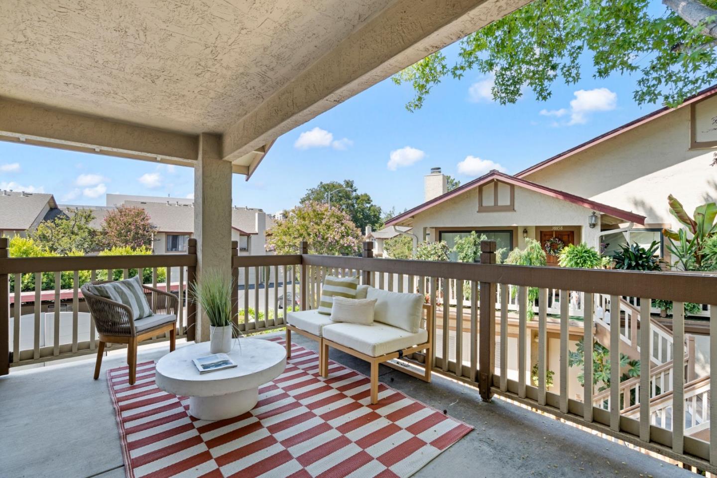 38872 Cherry Glen Common Fremont, CA 94536 - Photo 5 of 22 a balcony with wooden floor and outdoor seating