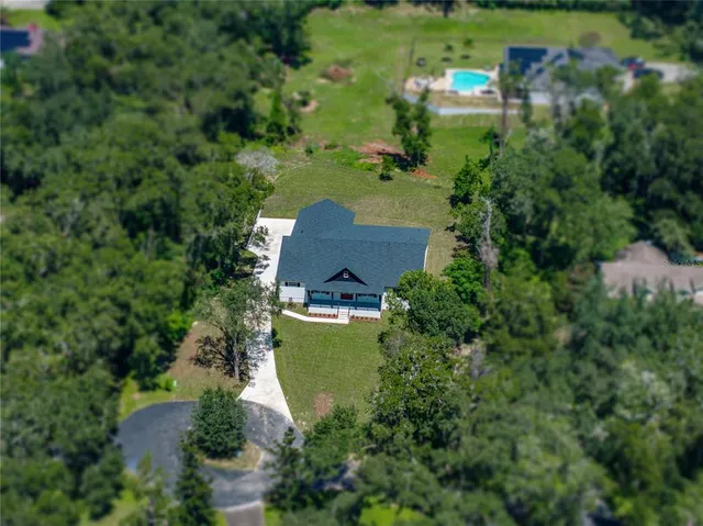 an aerial view of a house with a yard