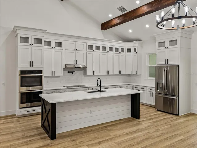 a kitchen with a stove and a wooden floor