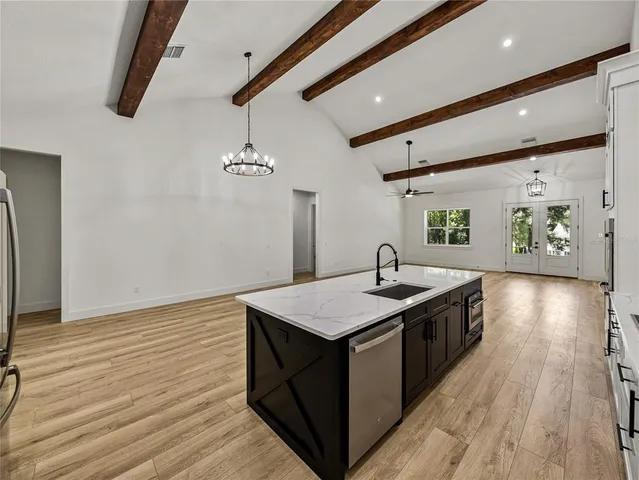 a kitchen with stainless steel appliances a sink stove and cabinets