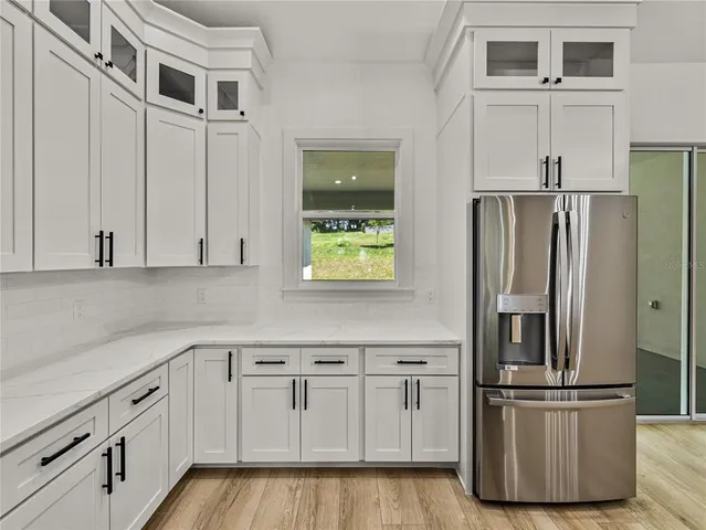 an empty room with window and ceiling fan