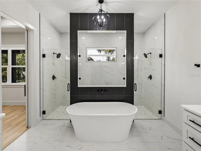 a view of empty room with wooden floor and ceiling fan