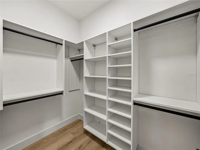 a bathroom with a granite countertop toilet and a shower