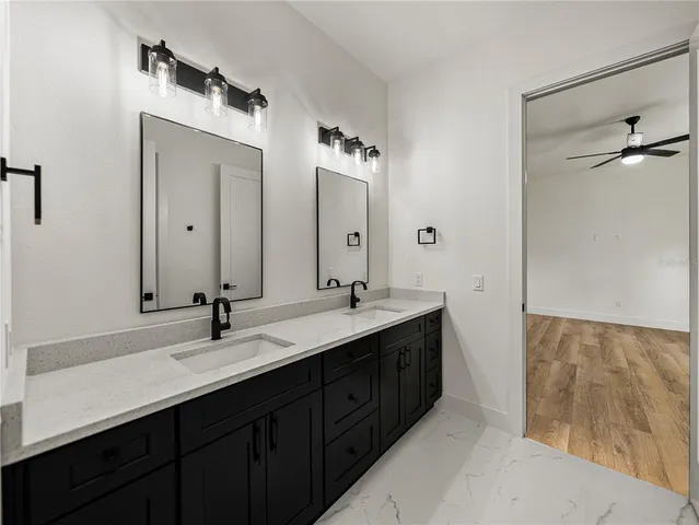 an empty room with a window and ceiling fan