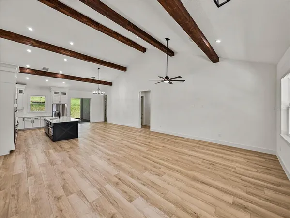 a large room with fireplace and windows