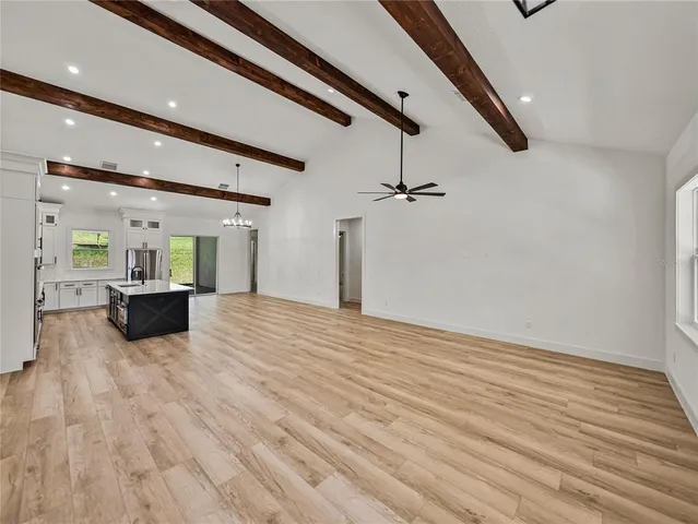 a large room with fireplace and windows