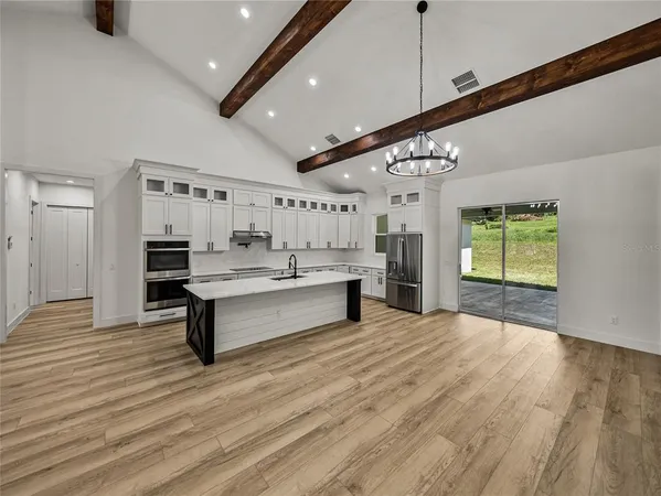 a kitchen with stainless steel appliances granite countertop a sink and cabinets