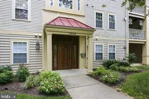 a view of a brick house with potted plants