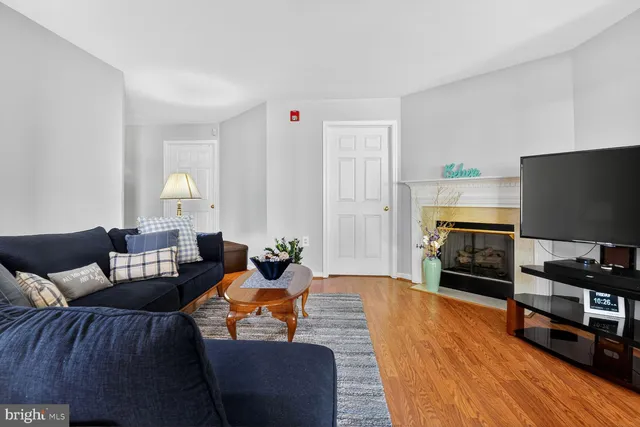 a living room with fireplace furniture and a flat screen tv