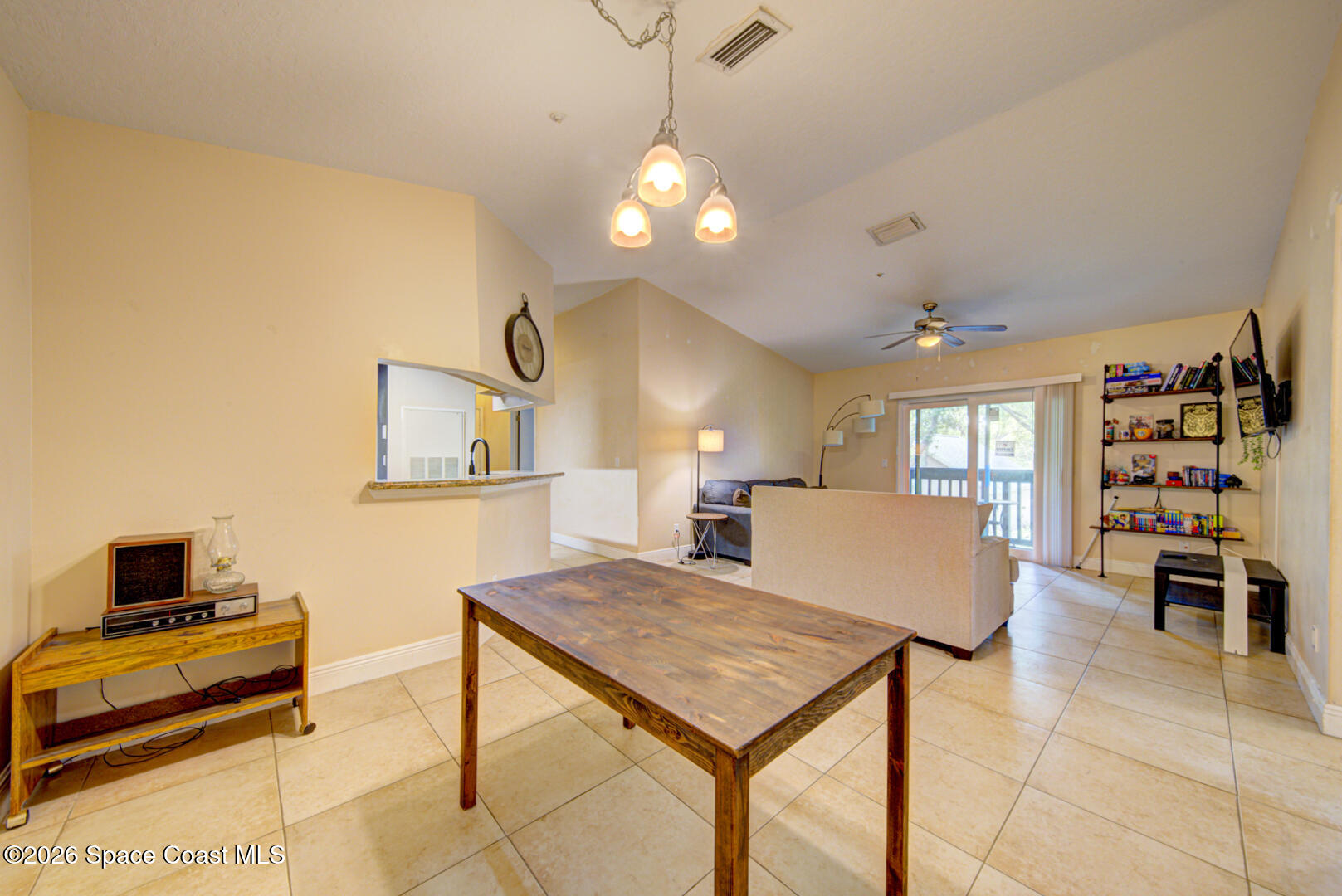 7667 North Wickham Road, Unit 1416 Melbourne, FL 32940 - Photo 15 of 41 a living room with furniture a flat screen tv and a table