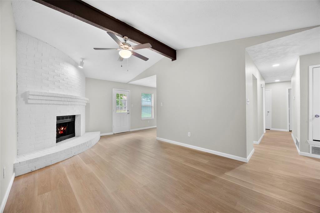 6219 Kelly Elliott Road Arlington, TX 76001 - Photo 4 of 17 Living room has pretty flooring and gorgeous fireplace!