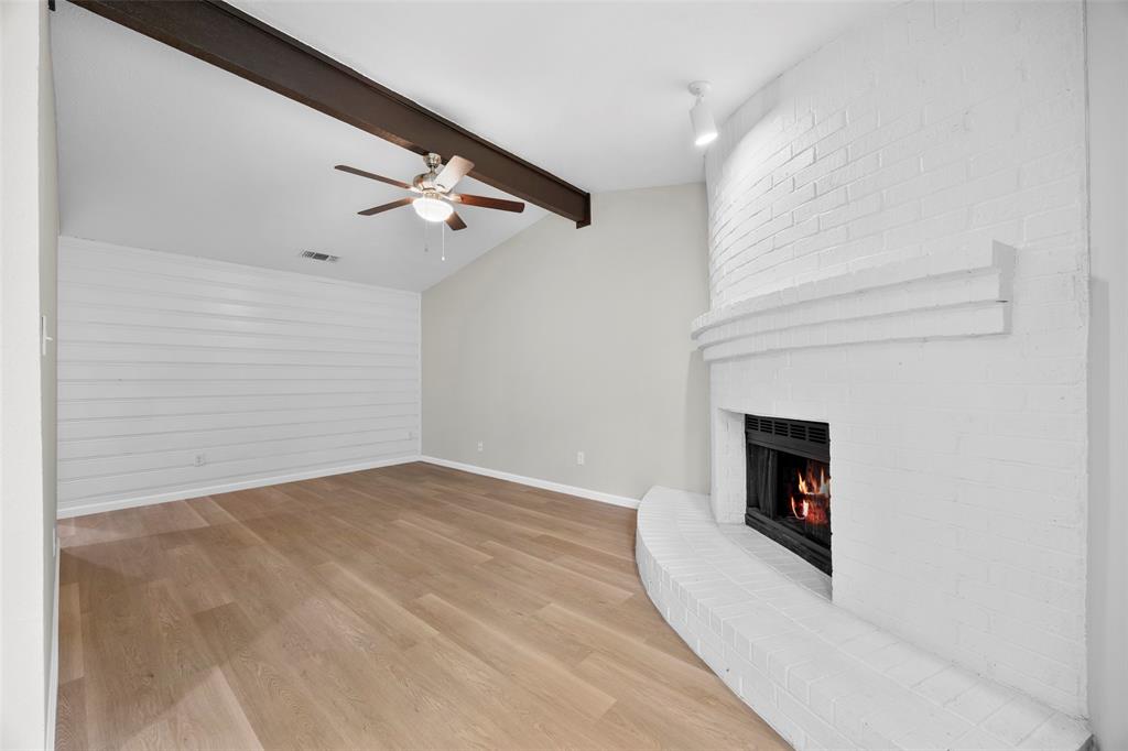 6219 Kelly Elliott Road Arlington, TX 76001 - Photo 5 of 17 Living room has pretty flooring, gorgeous fireplace, and a super cool shiplap wall!