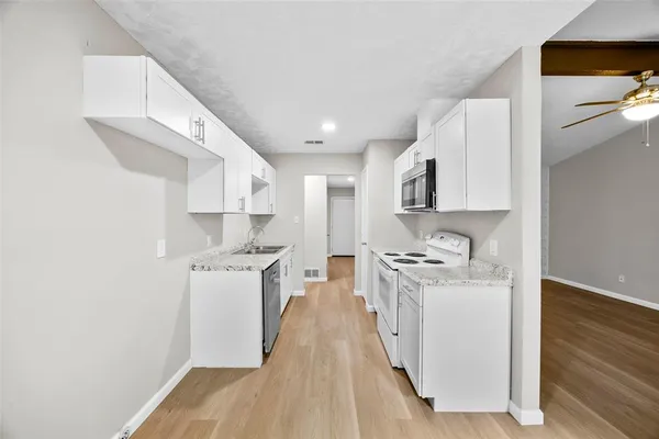 a kitchen with stainless steel appliances granite countertop a stove and a sink