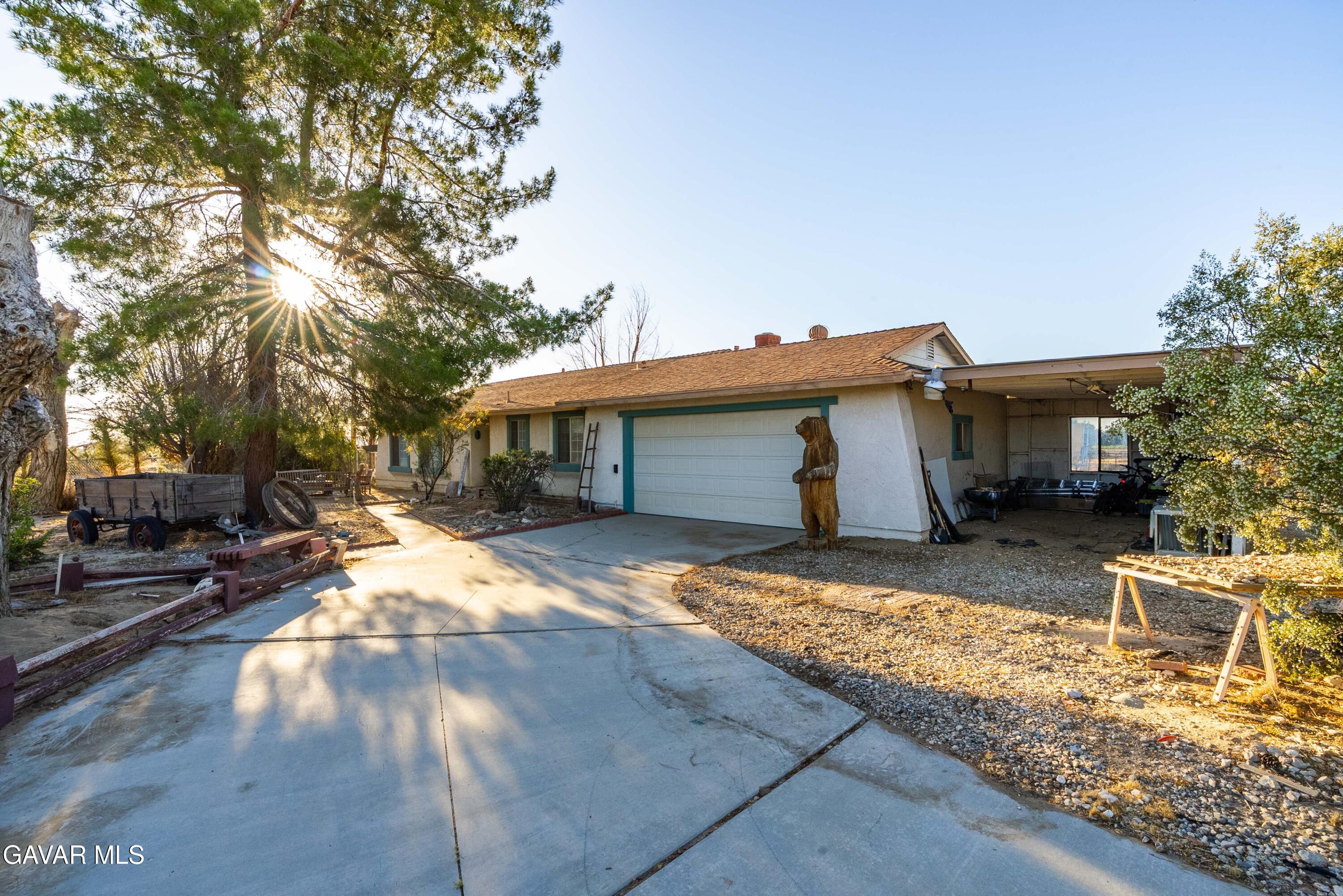 20539 East Ave R Palmdale, CA 93591 - Photo 6 of 55 a front view of a house with a yard
