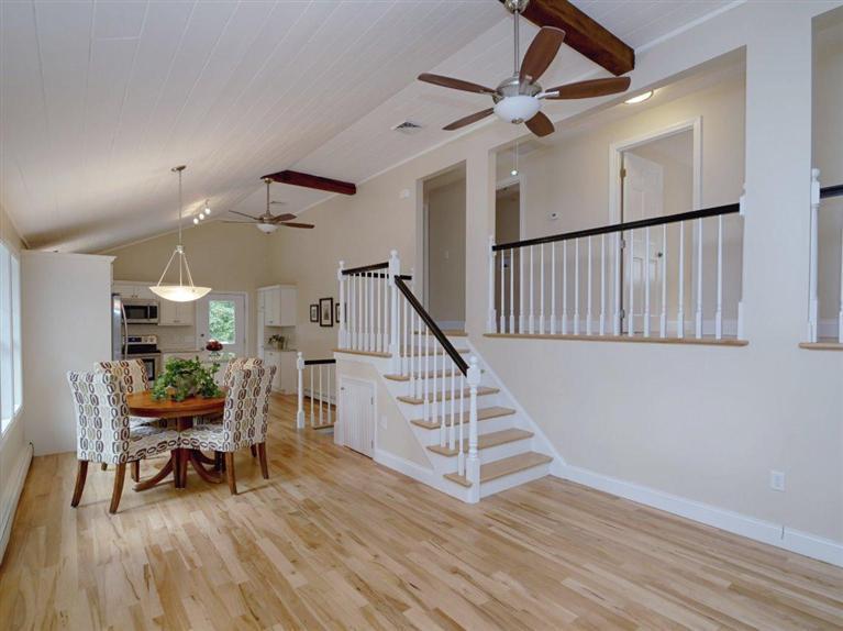 537 Scraggy Neck Road Cataumet, MA 02534 - Photo 11 of 33 a living room with wooden floor and a dining table with wooden floor