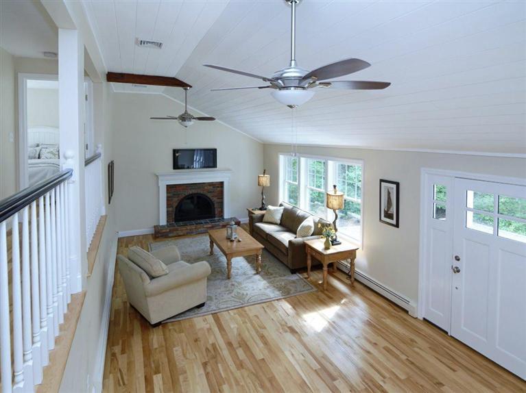 537 Scraggy Neck Road Cataumet, MA 02534 - Photo 18 of 33 a living room with furniture and a fireplace